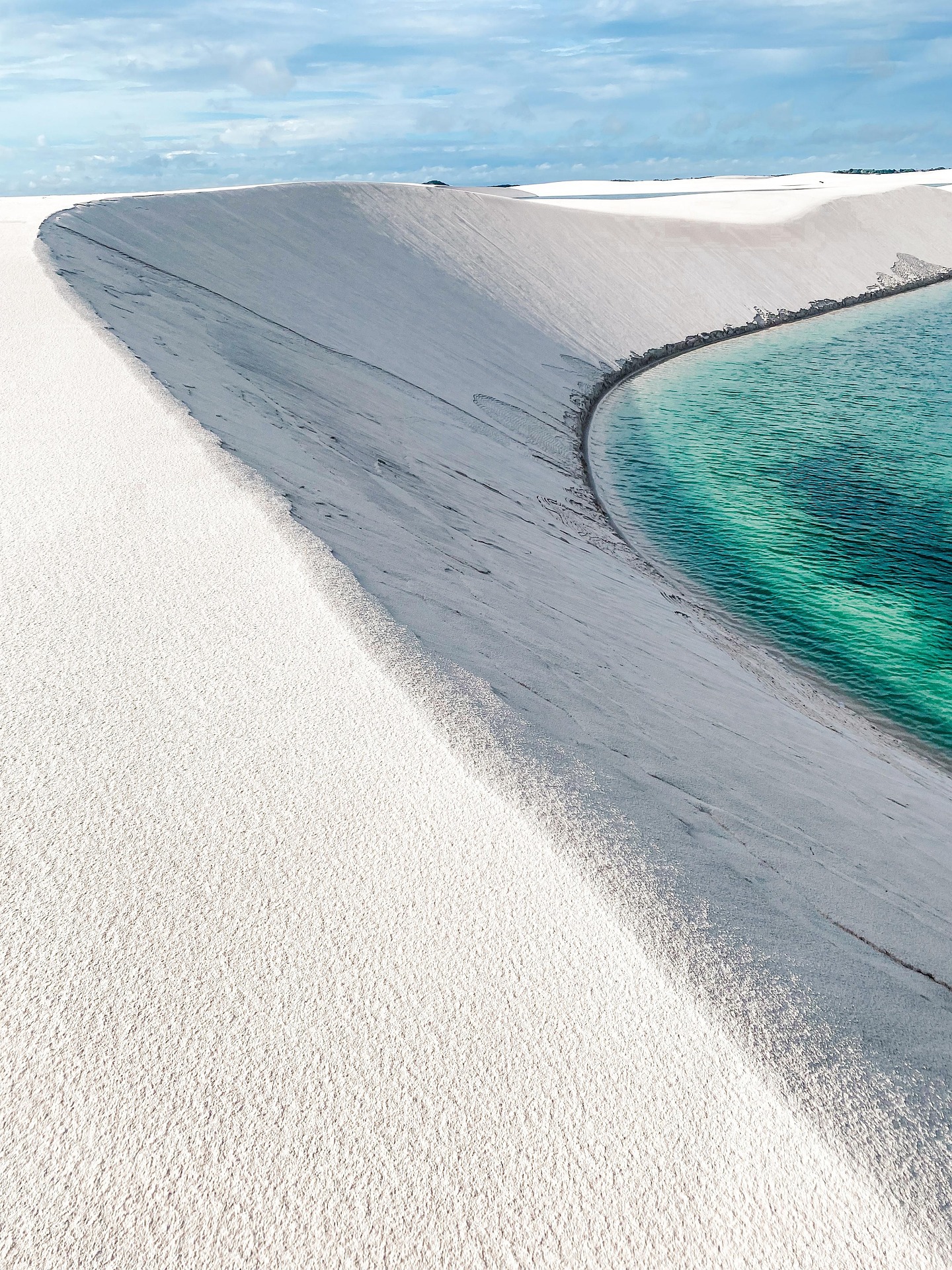 Turquoise lagoon framed by Lençóis Maranhenses dunes