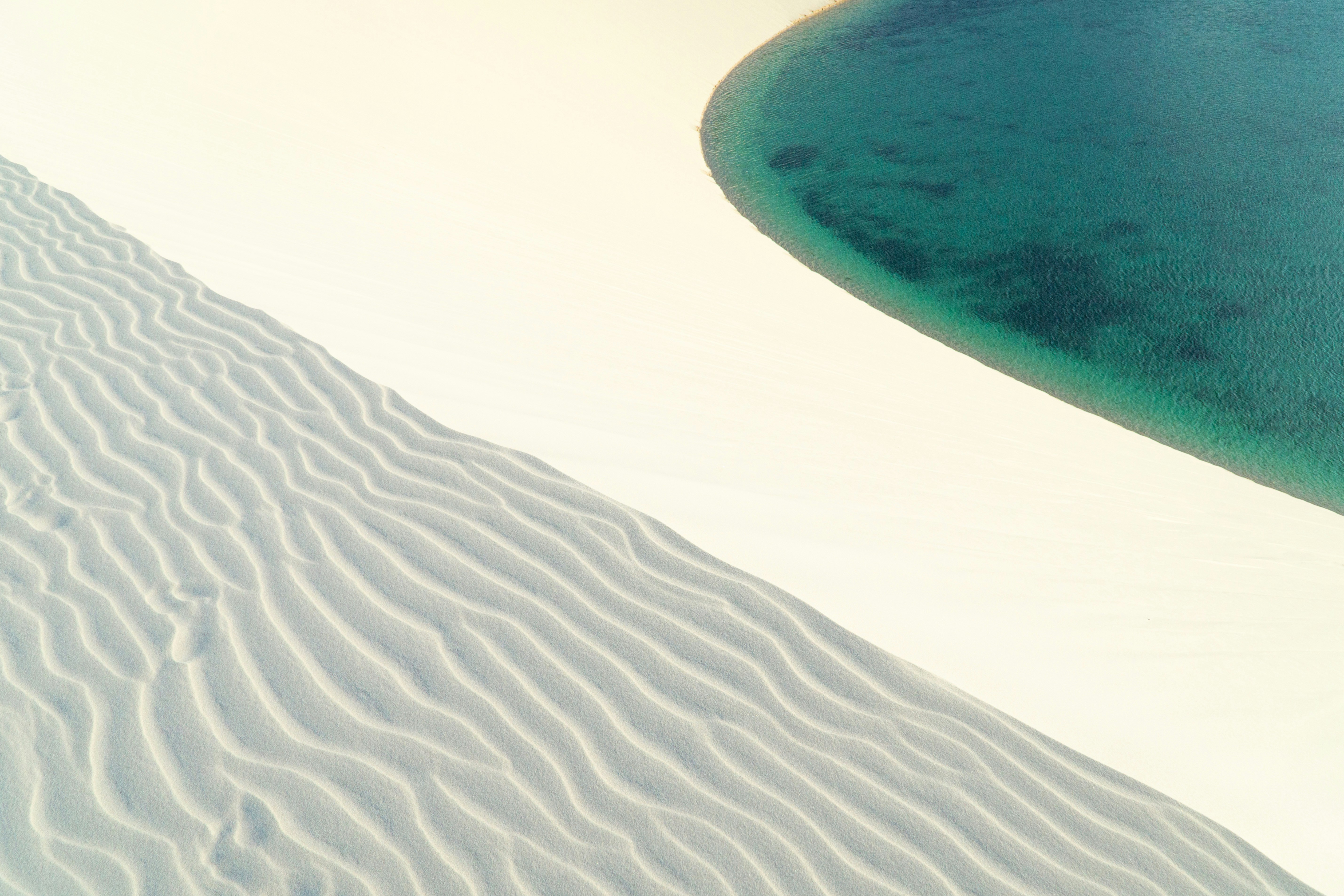 Aerial view of crystal-clear lagoons and white dunes