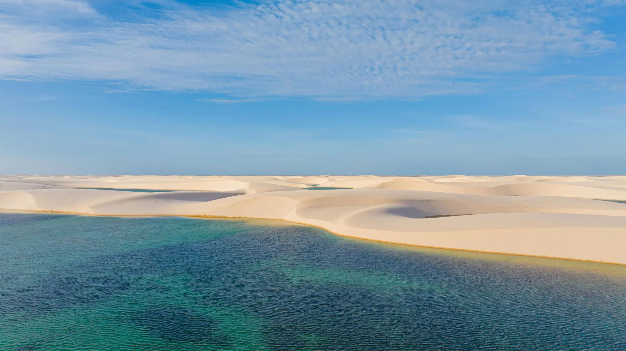 Turquoise lagoon framed by Lençóis Maranhenses dunes