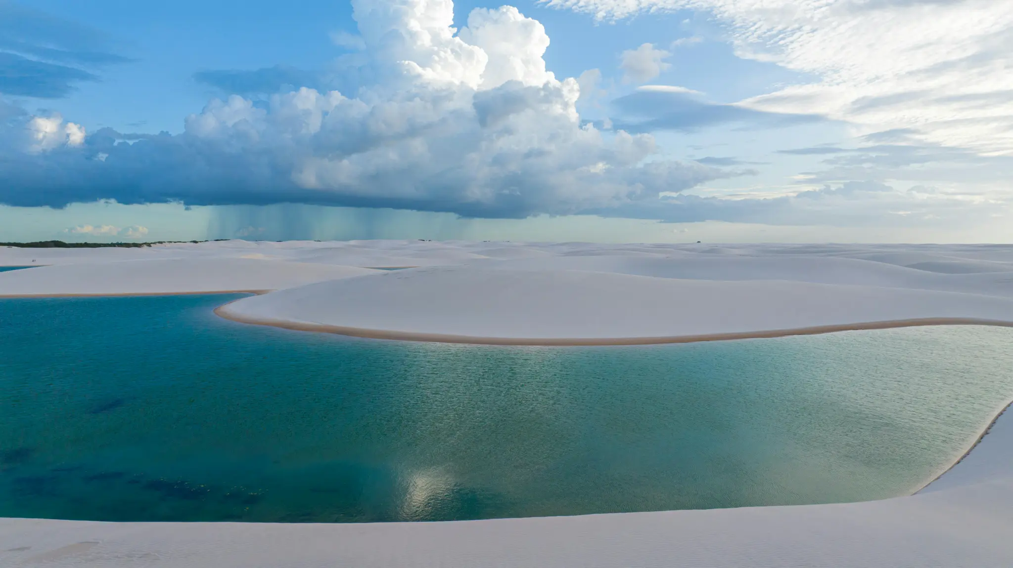 A tranquil lagoon beneath the vast sky of Lençóis Maranhenses