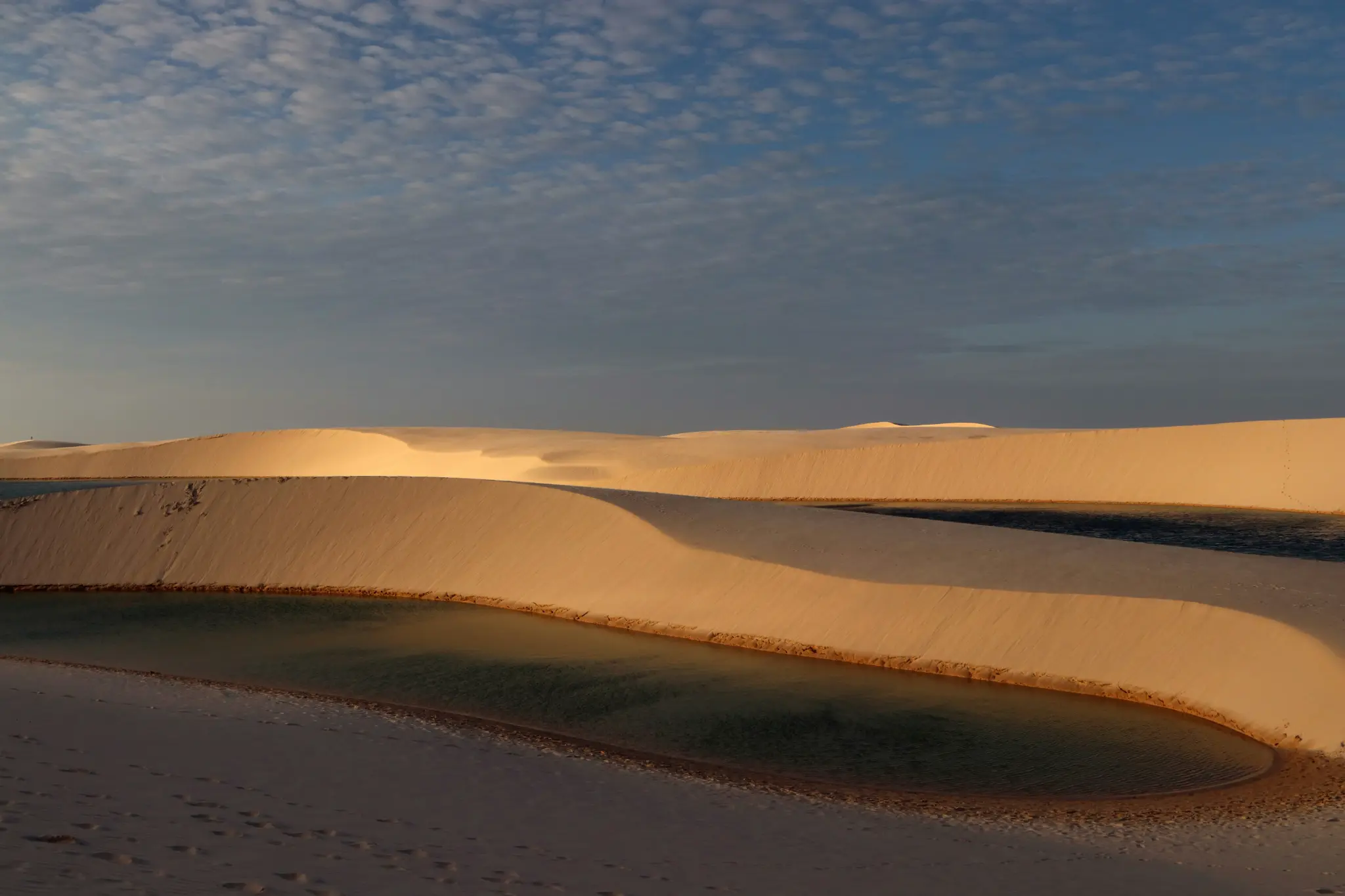 Crystal-clear lagoon framed by the Lençóis Maranhenses dunes