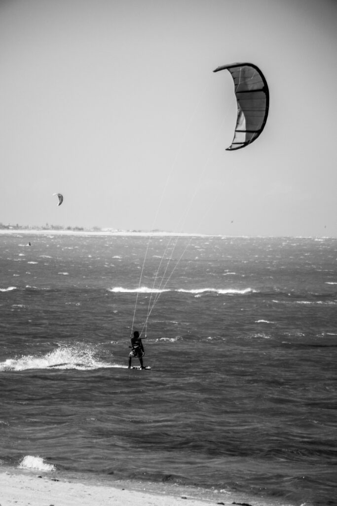pexels-photo-12820377-12820377 Dynamic black and white shot of a kitesurfer in action at Barra Grande, Brazil.