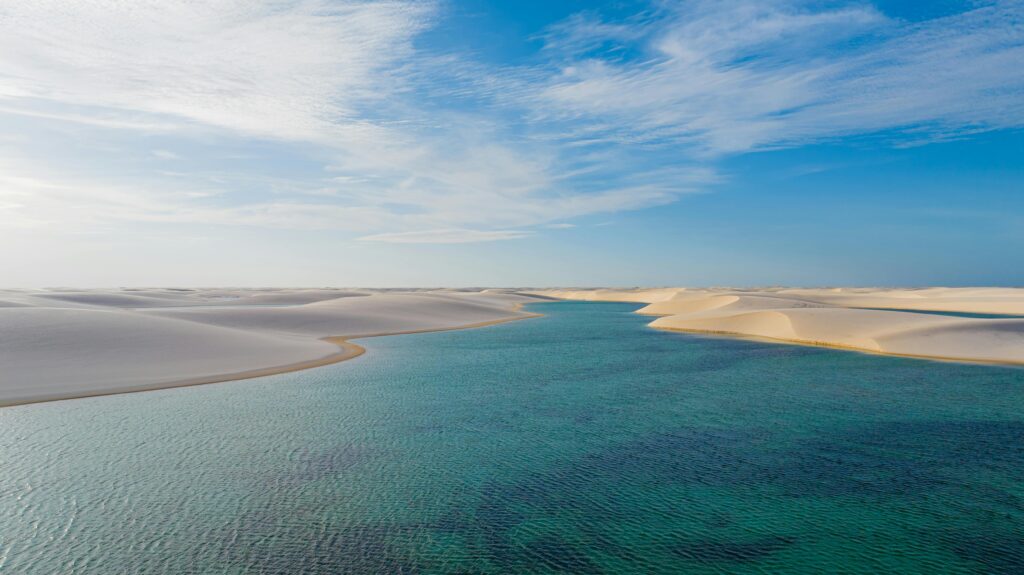 pexels-photo-27688574-27688574 A breathtaking view of sand dunes and clear water in Barreirinhas, Brazil's Lencois Maranhenses.