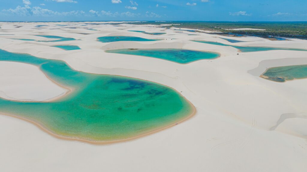 Stunning aerial capture of turquoise lagoons amidst white sand dunes in Lençóis Maranhenses, Brazil.