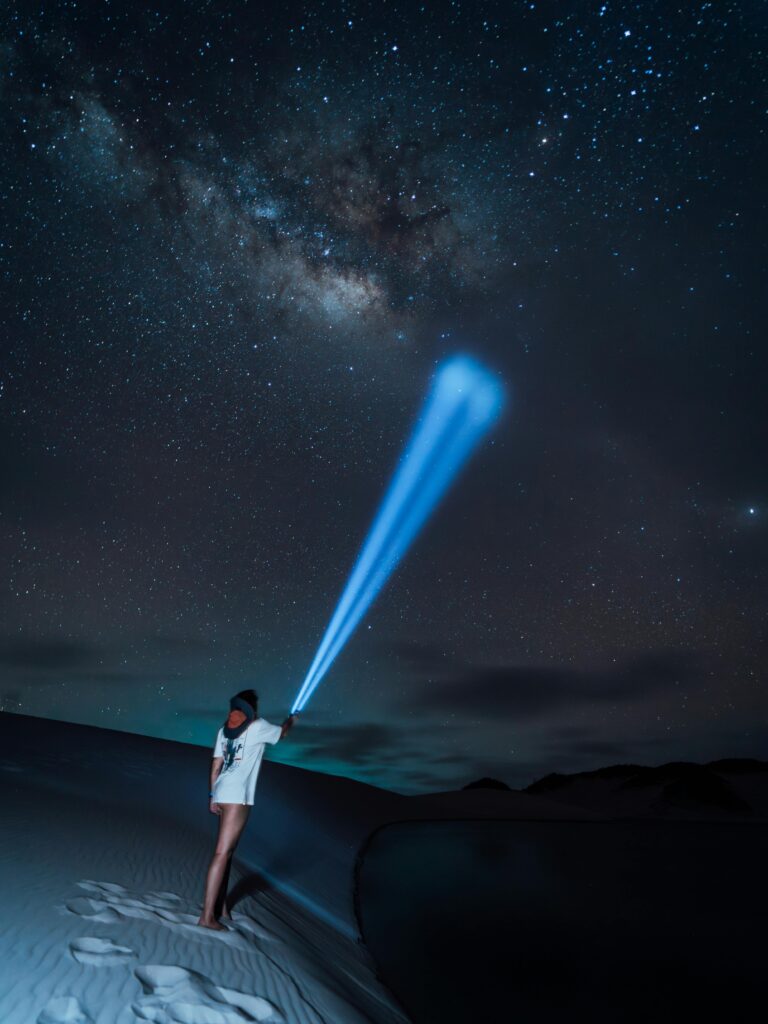 pexels-photo-32794144-32794144 Person illuminates Milky Way with flashlight in Maranhão's desert nightscape.