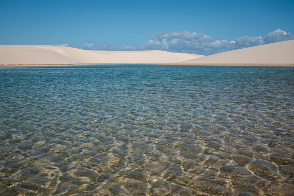 pexels-photo-32895812-32895812 A stunning landscape of sand dunes and a pristine lagoon in Lençóis Maranhenses, Brazil.