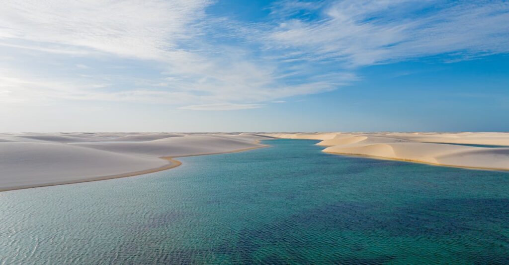 A breathtaking view of sand dunes and clear water in Barreirinhas, Brazil's Lencois Maranhenses.