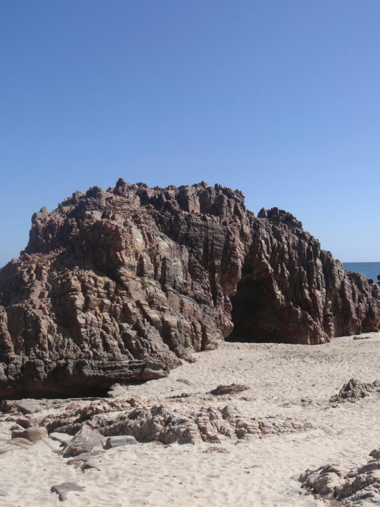 pexels-photo-14209653-14209653 Stunning view of rock formation on sandy beach under clear blue sky in Jericoacoara.