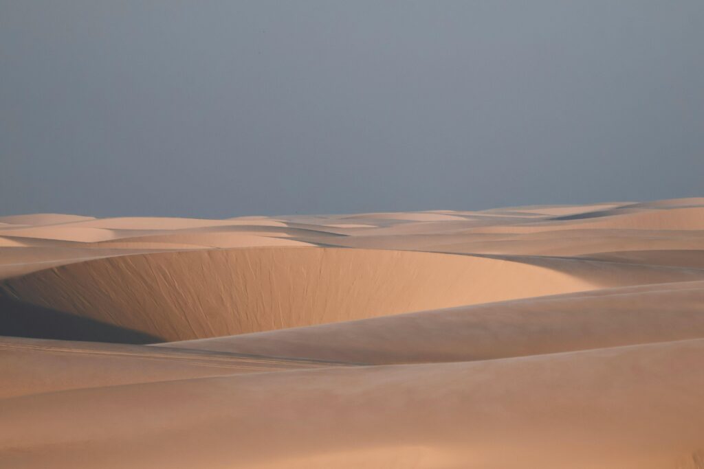Capture the serene beauty of Lençóis Maranhenses' sands during sunrise, Maranhão, Brazil.